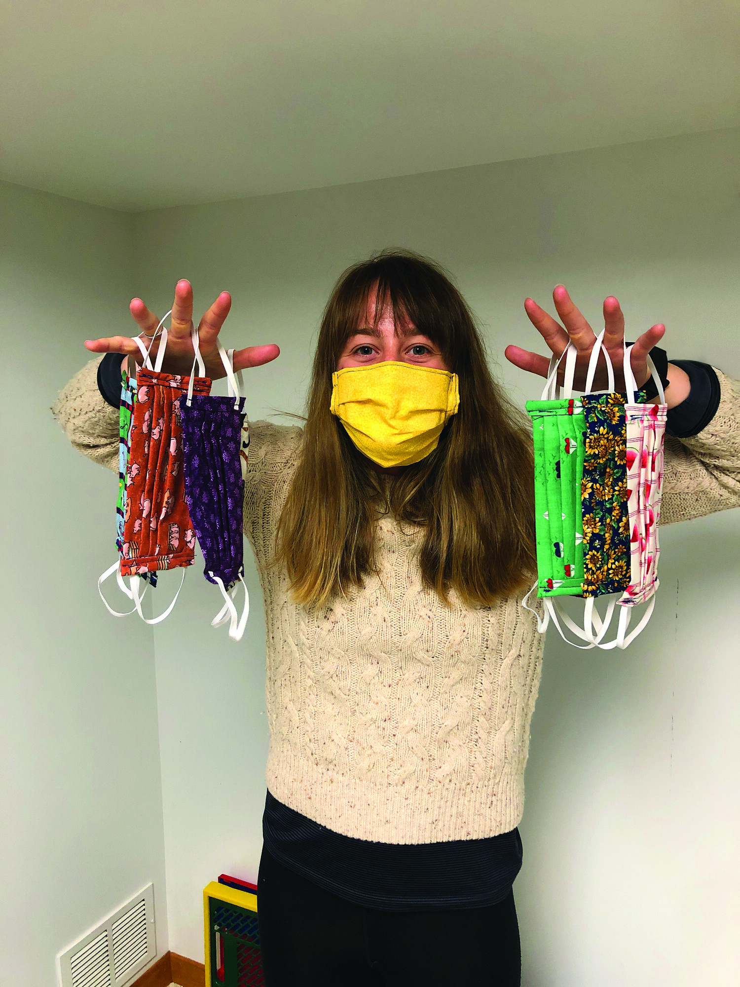 Natalie Stratton holding colorful masks