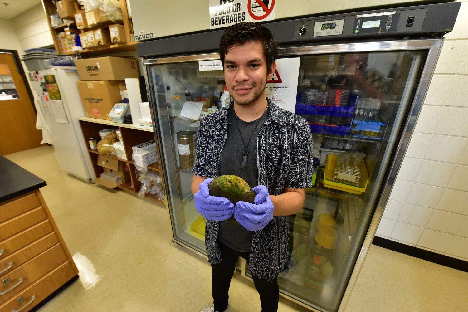 Photo of Steven Gonzalez holding a freshwater sponge
